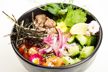 Poke salad with beef in a bowl. Ingredients Beef, Nameko mushrooms, cherry tomatoes, rice, cucumber, red onion, Kim Chi sauce, Ponzu sauce, nori, sesame seeds, cilantro, lime. Asian salad concept