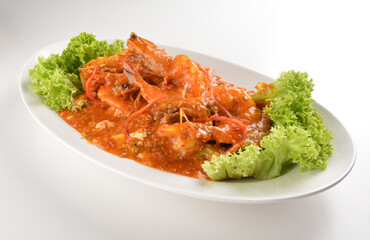 chef cook stir fried big tiger prawn seafood with chilli crab spicy red sauce in plate on white table seafood restaurant asian cafe halal chinese banquet menu