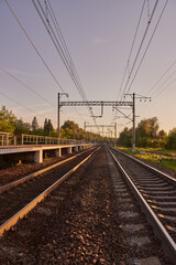 Fototapeta na wymiar Industrial landscape with rails and railway on sunset.