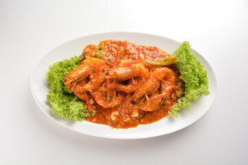 chef cook stir fried big tiger prawn seafood with chilli crab spicy red sauce in plate on white table seafood restaurant asian cafe halal chinese banquet menu