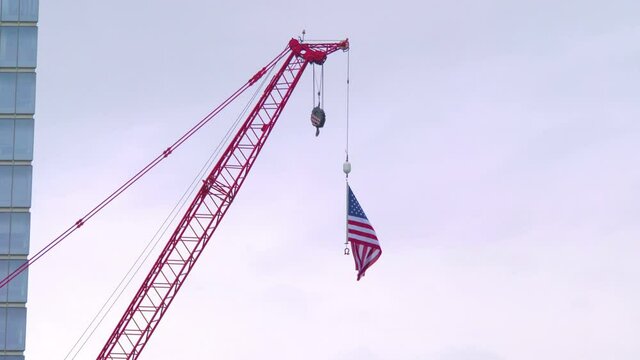 United States flag waving on the construction crane in New York in 4K slow motion 60fps