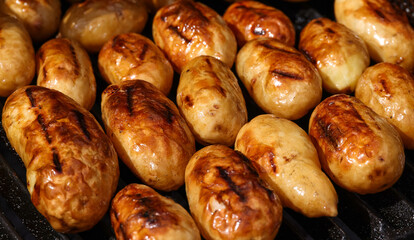 Cooking new potato in charcoal grill