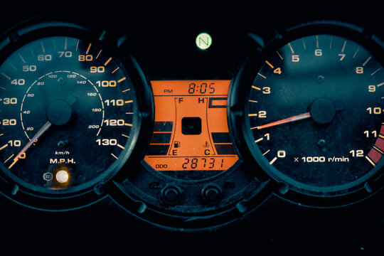 Motorcyclist turns the ignition key of the motorcycle and the tachometer needle swings smoothly. Motorbike dashboard. Concept of travel, leisure sports and hobbies. Close up shot
