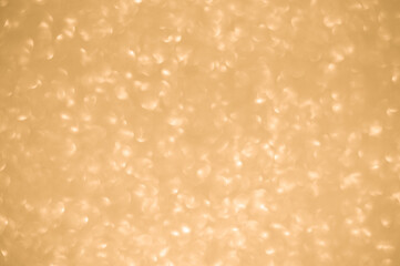 Gold glitters background. shimmering blur spot lights Bokeh Shiny gold light background.