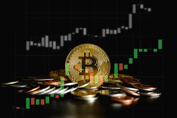 Close up of cryptocurrency bitcoin on black background with trading graph