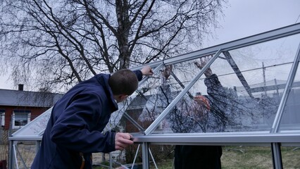 Fototapeta premium Green house construction at the garden in spring
