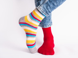 Men's legs and bright socks. Without shoes. Close-up. Style, beauty and elegance concept