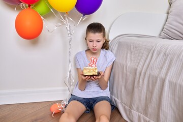 Birthday eleven years old, preteen girl with a small cake and candles 11