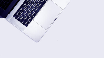 Minimalistic silver laptop on gray background with copy space, clean background