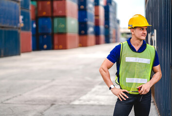 Professional engineer container cargo foreman in helmets working standing and using walkie talkie checking stock into container for loading.logistic and business export