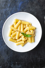 pasta is ready to eat macaroni ziti or penne main course italian cuisine on the table healthy food meal snack copy space food background rustic. top view