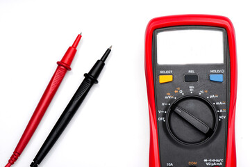 Electronic digital multimeter isolated on white with probes. Digital multimeter with red and black...
