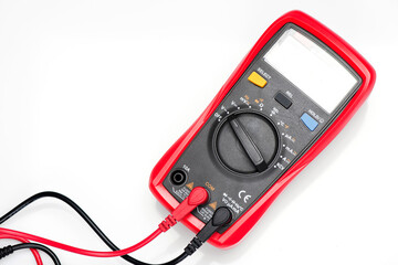 Electronic digital multimeter isolated on white with probes. Digital multimeter with red and black leads. Electronic multimeter isolated on white background close up