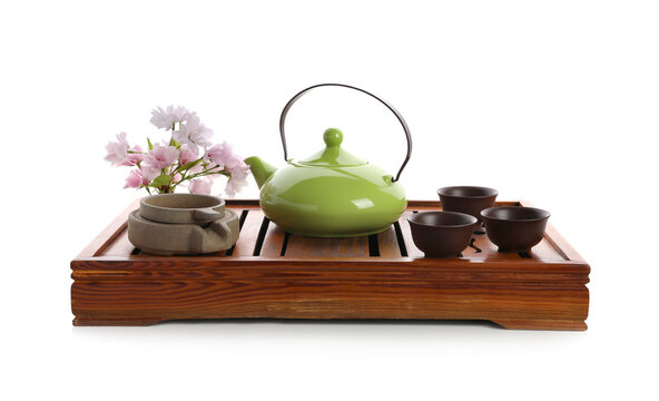 Beautiful set for traditional tea ceremony and sakura flowers on white background