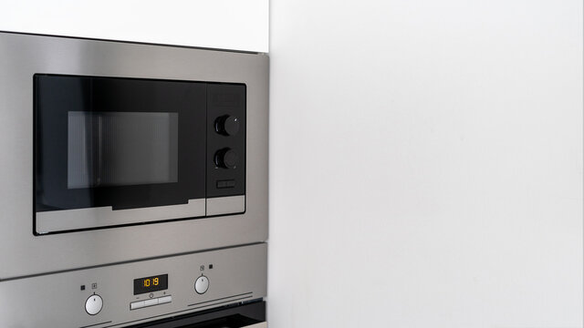 Steel microwave with time display in kitchen