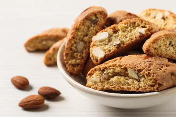 Traditional Italian almond biscuits (Cantucci) on white wooden table, closeup