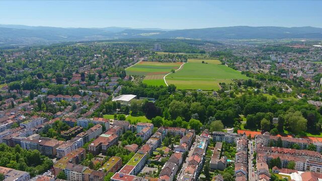 Basel: Aerial view of city in Switzerland at border with France and Germany, city outskirts with modern residential buildings, clear blue sky - landscape panorama of Europe from above