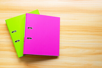 Office folders on wooden table background. Top view