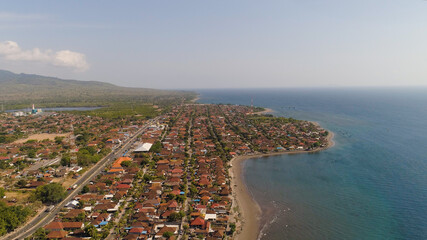 Aerial view coastal port city Gilimanuk place where ferry port for departure from Bali to the island of Java is located. Coastal city on the coast.
