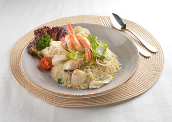 chef wok fried rice with seafood prawn, octopus and fish with salad side asian halal menu