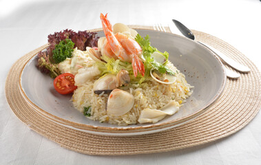 chef wok fried rice with seafood prawn, octopus and fish with salad side asian halal menu