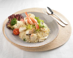 chef wok fried rice with seafood prawn, octopus and fish with salad side asian halal menu