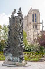 Paris, France - 05 02 2021: View of Notre-Dame from Square Rene Viviani and stele in memory of the...