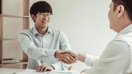 Business personage handshake, Asian business women congratulate on being a corporate partnership with European man investors, Friendship, Sign language greetings, Successful business negotiations.