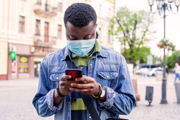 People in masks stand queue keeping social distance