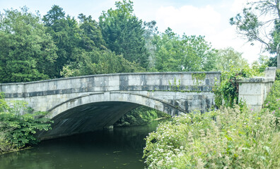Fototapeta na wymiar Old stone bridge over the River Test in the Hampshire town of Romsey