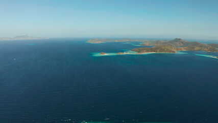 aerial drone tropical islands with blue lagoons, coral reef and sandy beach. Palawan, Philippines. Islands of the Malayan archipelago with turquoise lagoons.