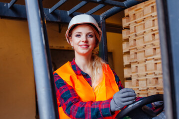 The young woman is driving a forklift in a warehouse