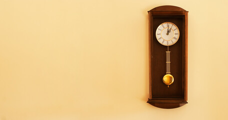 Retro clock on a wall with some copy space for additional content. - obrazy, fototapety, plakaty