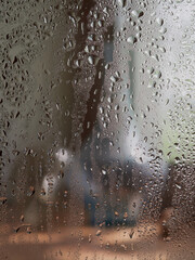 Rain drops on window glasses surface with sunset. drops on glass spray on window background for dark text selective focus