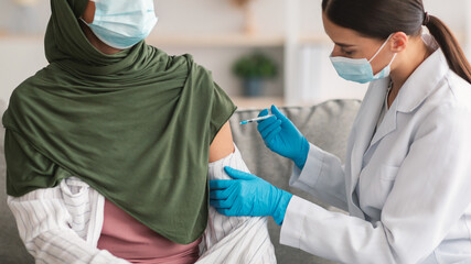 Unrecognizable Muslim Lady Getting Vaccinated Against Covid-19 Indoors