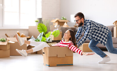Cheerful couple having fun in new apartment