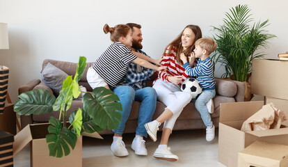 Happy family playing on sofa during relocation - obrazy, fototapety, plakaty