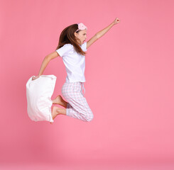 Excited woman with pillow jumping and screaming