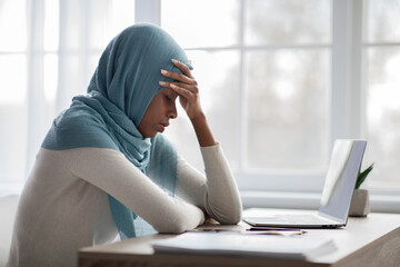 Working Stress. Upset Black Woman In Hijab Sitting At Desk With Laptop