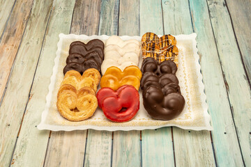 Tray of mini chocolate palm trees of various flavors on wooden table