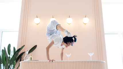 Flexible girl messing around and do handstand at home. concept of quarantine time during self...