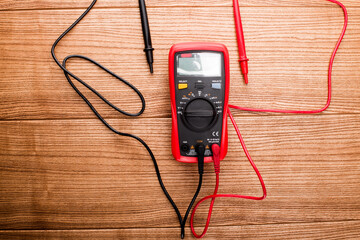 Electronic digital multimeter isolated on white with probes. Digital multimeter with red and black...