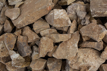 The texture of folded crushed yellow limestone.