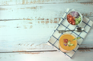 Spanish gazpacho or salmorejo soup on a white wooden table.