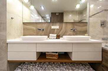 Exclusive bathroom with glass shower, basin and big mirror