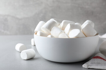 Fototapeta na wymiar Delicious puffy marshmallows on grey table, closeup