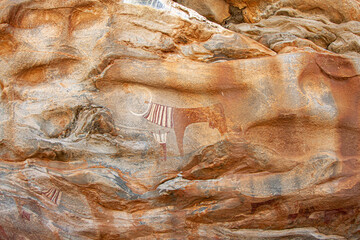 Livestock cow and human rock paintings on the surface of the rock in Laas Geel, Somaliland