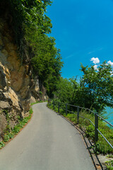 road in the mountains next to lake