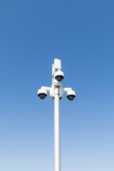 White pole with white 360 degree video surveillance cameras