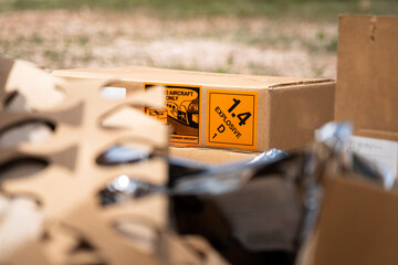 Explosive triangle placard sign on the carton box, to demonstrate the dangerous material inside. Industrial safety sign and symbol on the object.